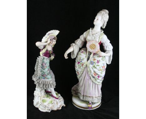 Two late 19th Century hard paste porcelain figuresThe first modelled in the form of a Victorian lady holding a fan and wearin