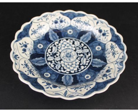 Two 18th Century Worcester porcelain platesThe first of circular form with wavy edge, painted with a Chinese Kangxi Lotus pat