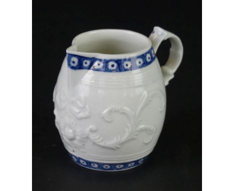 An 18th Century Worcester cream jugWith relief moulded decoration of a central bowl and scrolls, crescent mark to base, heigh