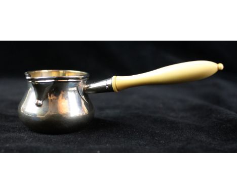 A Victorian silver miniature brandy saucepanOf typical bellied form, with a flared rim and pouring spout, to a carved ivory p