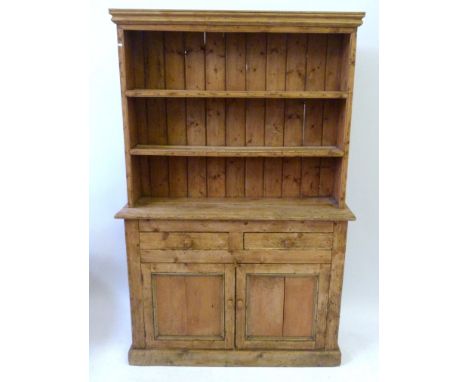 An attractive antique pine kitchen dresser late 19th/early 20th CenturyWith upper section of two fixed shelves with plate bar