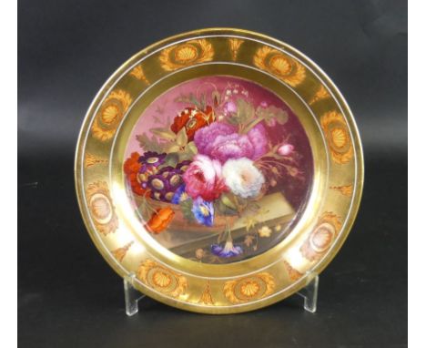 A 19th Century Rockingham porcelain plateOf circular form, having hand-painted central panel depicting floral sprays, diamete