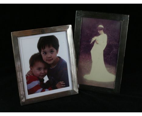 Two silver photograph framesOf rectangular form, with engine turned detail, vacant cartouche, loaded, makers marks indistinct