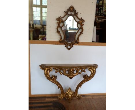 A Louis XV style gilt wood console table and mirror, mid to late 20th CenturyThe wall hanging console table with elaborate fl