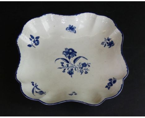 An 18th Century Worcester blue and white dished bowlOf square form with basket weave rim, having floral sprays, crescent mark