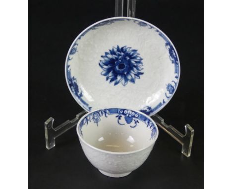An 18th Century Worcester blue and white tea bowl and saucerRelief moulded in the 'Chrysanthemum' pattern, crescent mark to b