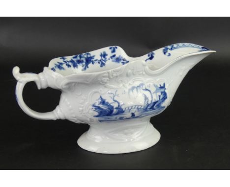 An 18th Century Worcester blue and white sauce boatRelief moulded with floral sprigging, decorated in the 'Fisherman on a Tow