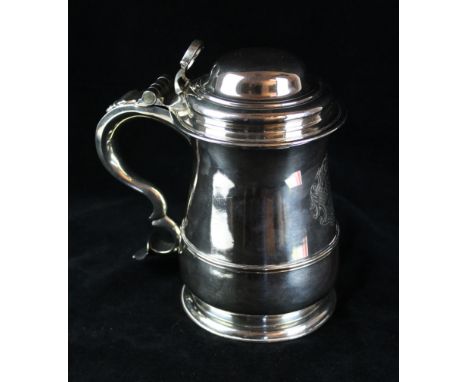 A George II silver lidded tankardOf conventional bellied form with mid-rib, with openwork thumb-piece, the double scroll hand