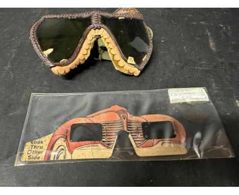A pair of U.S. goggles, dated 1944 and a Plymouth Polaroid viewer in the form of a Plymouth car, dated 1941.
