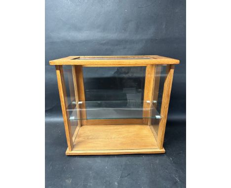 A glass tabletop display case with glass shelf, 18" wide x 17" tall x 10" deep.