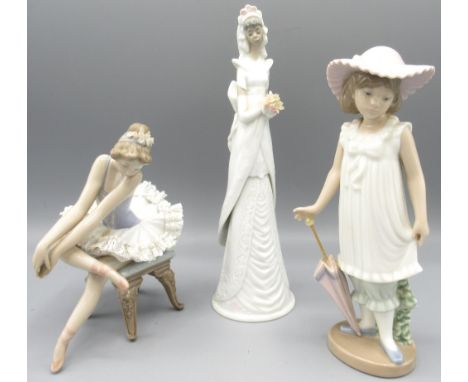 Lladro figure of a seated ballet dancer, H14.5cm; Nao figure of a girl with parasol; and a Lladro bell modelled as a bride, H