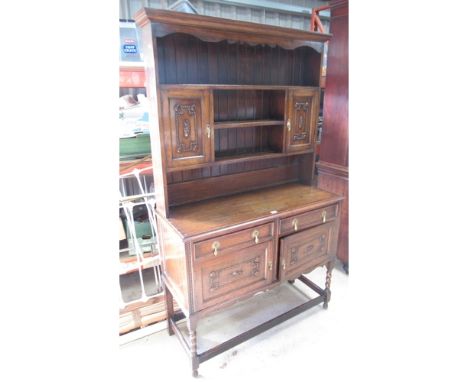 C20th oak dresser, twin shelf back with two cupboards above two further cupboards and two drawers, W126cm D48cm H210cm