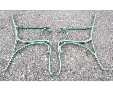 Two sets of cast iron bench ends with scroll design 