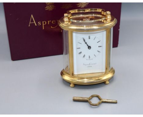 Asprey &amp; Garrard London, 8 day oval brass carriage clock timepiece, signed white enamel Roman dial, five glass case, 11 j