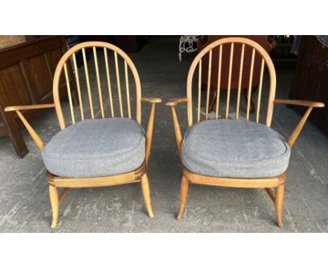 Pair of Ercol hoop and stick back arm chairs, with loose seat cushions on turned outsplayed supports, (2) 