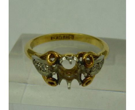 An 18ct gold and platinum ring, stone missing, weight 3.7g, size O