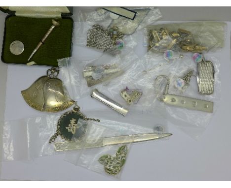 Assorted silver including tie pins, a penknife, letter opener, charm bracelet, a silver golf tea pencil and marker, etc.