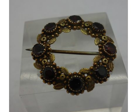 A gold and garnet brooch