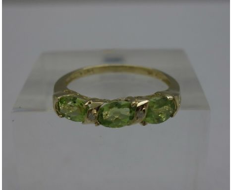 A 9ct gold, peridot and diamond ring, weight 1.5g, size O