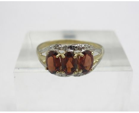 A 9ct gold, diamond and red stone ring, weight 1.4g, size O