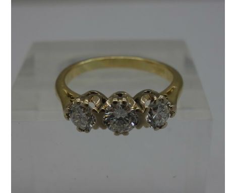 An 18ct gold three stone diamond trilogy ring, approximately 0.85ct diamond weight, weight 3.4g, size K