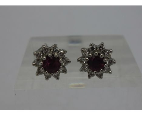 A pair of gold, ruby and white stone earrings, weight 3.8g