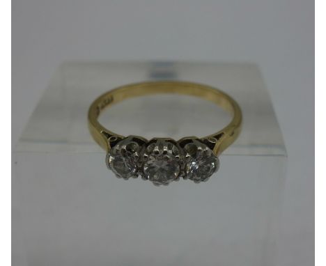 An 18ct gold and platinum set three stone diamond ring, weight 2.3g, size M