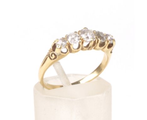 An early 20th century gold and diamond five stone ring. The graduated off-round old-cut stones approx. 0.70cts total, all cla