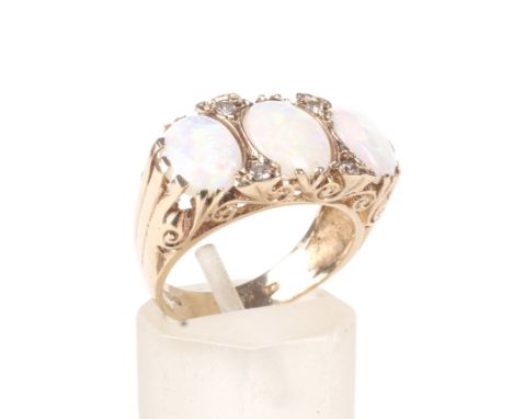 A vintage 9ct gold, opal and diamond carved half-hoop ring. The three graduated oval cabochon white opals display a medium pl