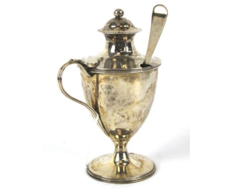 A Georgian silver mustard pot with later Georgian ladle. Of regency form raised on a pedestal base. Maker Robert Hennell 1 Lo