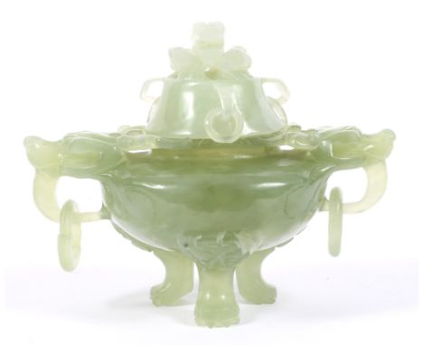 A 20th century Chinese light green hardstone lidded incense burner. The cover with pierced beast finial, suspending rings, wi