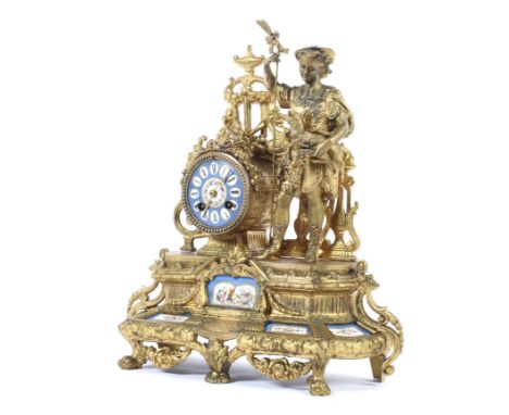 A gilt-metal and Sevres-style porcelain mounted mantle clock, circa 1900. Mounted with a shepherd flanked by trophies and ree