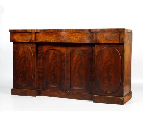 A Victorian mahogany four door chiffonier. The upper section of serpentine form with three frieze drawers above a central pan