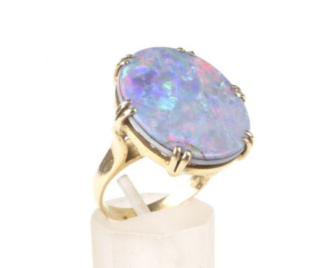 A vintage Italian gold and opal-doublet ring. The oval opal-doublet panel approx. 21.5mm x 17mm overall, claw set to a flat-s