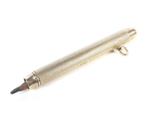 An early 20th century 9ct gold propelling pencil. With an engine-turned barrel, a plain rectangular reserve and suspension lo