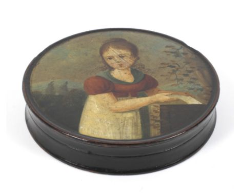 An early 19th century lacquered papier mache circular snuff box. Painted with a portrait of a girl  holding a letter before a