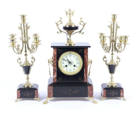 A clock and a candelabra. Comprising a late 19th century Continental slate, marble and gilt-metal mounted mantle clock and tw