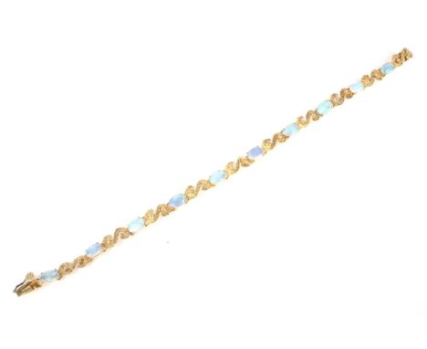 A vintage far eastern white opal bracelet. The ten slightly graduated oval cabochon opals display a pleasing play of mostly g