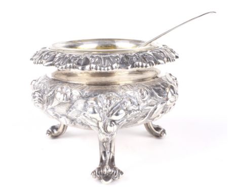 A fine silver gilt embossed open glass lined salt. The body decorated with flowers and foliage raised on cabriole supports to