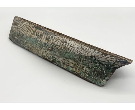 A rustic wooden model boat hull