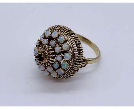 A 14ct gold articulated ring set with opals- the top section moves independently. Two stones missing, weight 6.5g