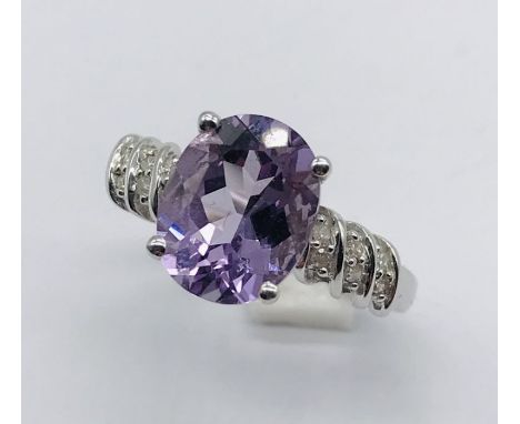 A 9ct white gold amethyst ring set with diamonds to the shoulders