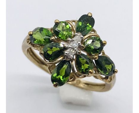 A 9ct gold dress ring set with tourmaline and diamond