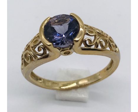 A 9ct gold amethyst ring with pierced decoration to each shoulder