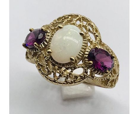 An opal and garnet 3 stone ring with filigree 9ct gold setting