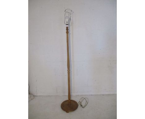 An oak standard lamp, lacking shade.