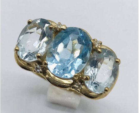 A topaz three stone ring set in 9ct gold