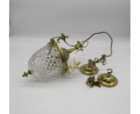 A brass ceiling lamp with glass shade.