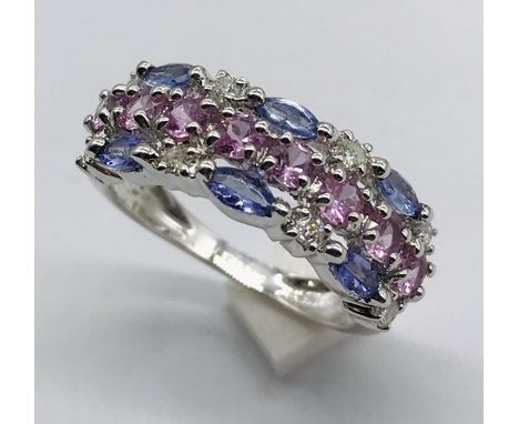 A diamond, topaz and amethyst dress ring set in 9ct white gold