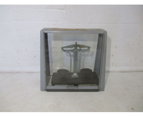 A set of Griffin scales in glass case